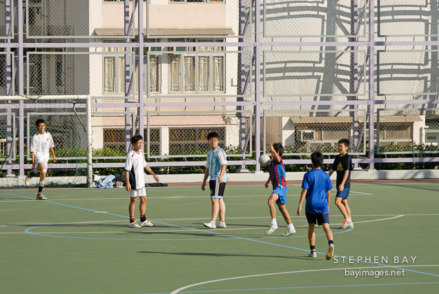 Boys playing soccer in Kowloon Park. Hong Kong, China.