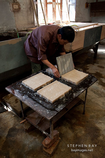 Laying thin sheet of pulp to create paper sheets. Jungshi Handmade Paper Factory, Thimphu, Bhutan.