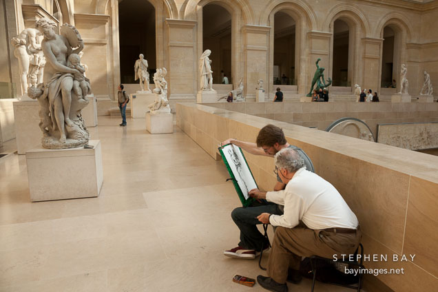 Teacher and student drawing at the Louvre. Paris, France.