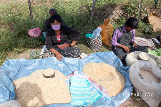 Woman selling puffed rice (zaw) at the weekend market. Punakha, Bhutan.