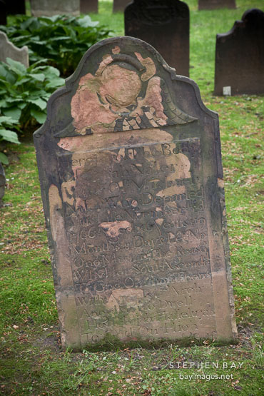 Old and worn tombstone at Trinity Church cemetery. New York City.