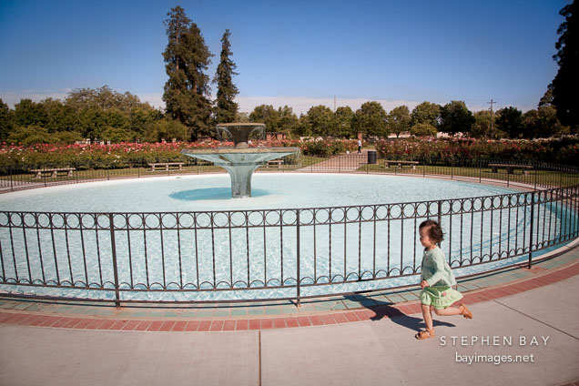 Girl running at the Municipal Rose Garden. San Jose, California.