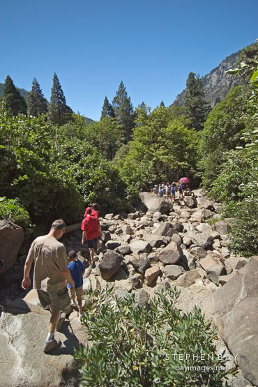Hikers at Bridalveil falls. Yosemite National Park, California, USA.