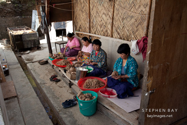 Cooked fiber being cleaned by women workers. Jungshi handmade paper factory, Thimphu, Bhutan.