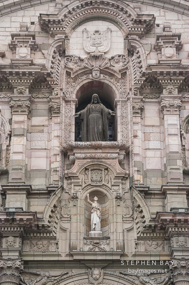 Front facade with Sacred Heart of Jesus and Apostle. Basilica Cathedral of Lima, Peru.