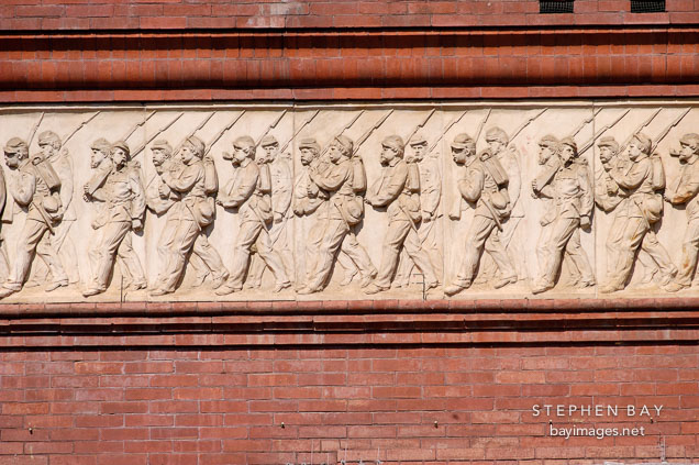 Facade of the National Building Museum depicting soldies marching with rifles. Washington, D.C., USA.