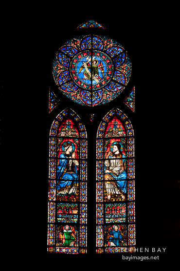 Stained glass window in Notre Dame Cathedral. Paris, France.