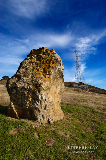 Large boulder and electric tower. Russian Ridge Open Space Preserve. California.