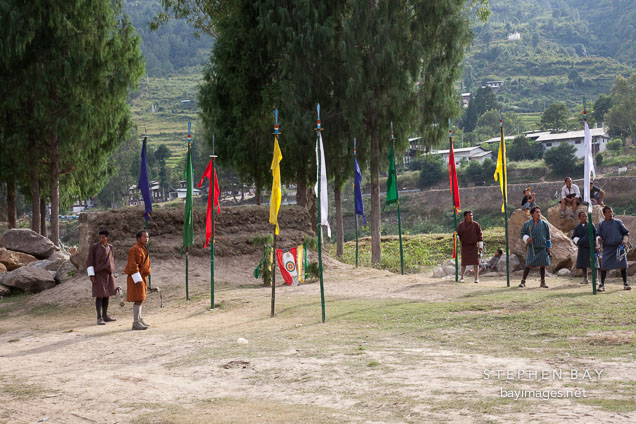 Archers waiting to see where their teammates will hit the target. Punakha, Bhutan.