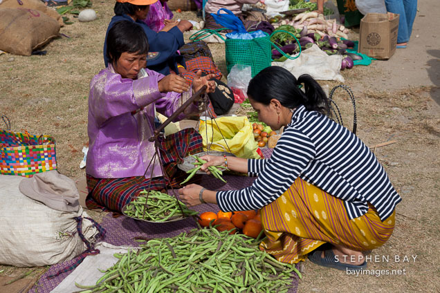 Weighing green beans at the weekend market. Punakha, Bhutan.