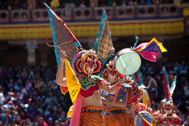 Ging dancer with flag and drums. Thimphu tsechu, Bhutan.