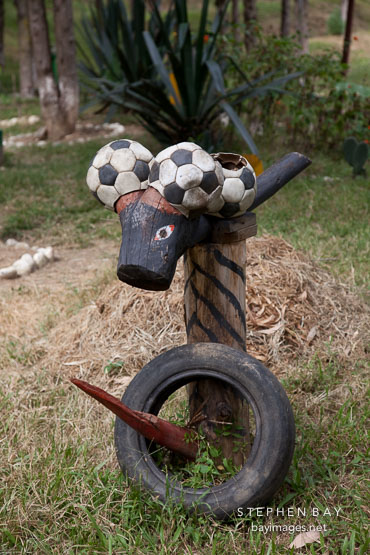 Odd figure made from soccer balls, tires, and a wood stake. Punakha, Bhutan.