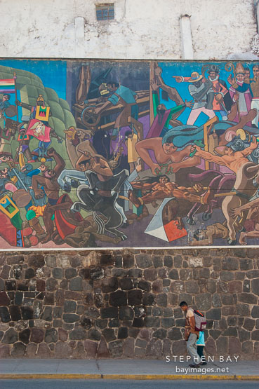 Walking under a mural. Cusco, Peru.