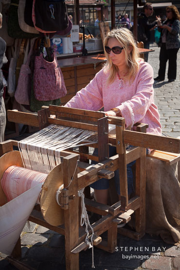 Woman weaving cloth on a loom. Prague, Czech Republic.