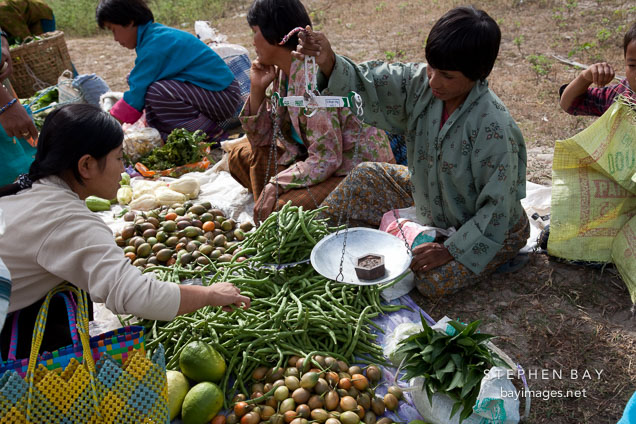 Woman purchasing green beans at the weekend market in Punakha.