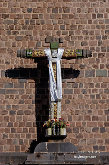 Cross outside Qoricancha, Temple of the Sun. Cusco, Peru