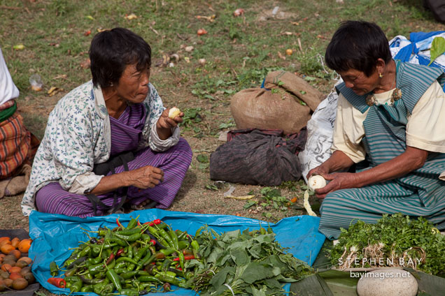 Two women selling produce at the weekend market.