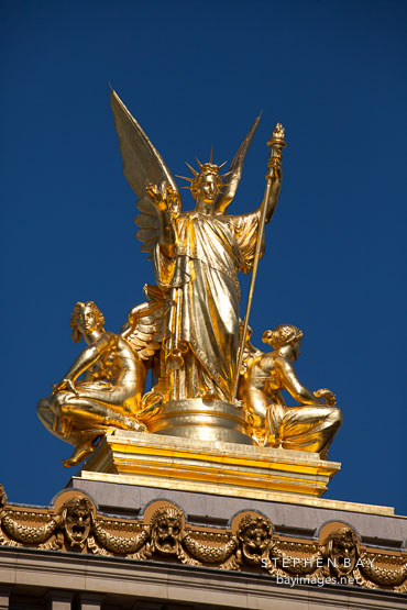 Gold statue atop the Palais Garnier. Paris, France.