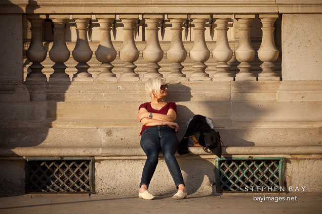Woman sitting on bench. Paris, France.