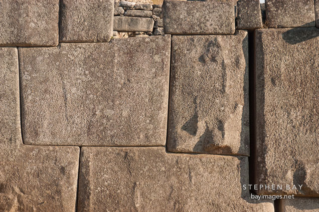 Stone wall at Machu Picchu with interlocking blocks. Peru.