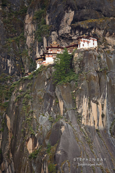 Taktshang Goemba (Tiger's Nest) monastery is build on a cliff face high above the valley floor. Paro Valley, Bhutan.