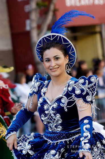 Woman wearing blue dress with silver embroidery. Carnaval's grand parade. San Francisco, California, USA.
