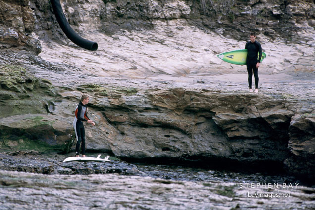 Surfers at Natural Bridges State Beach, Calfornia.