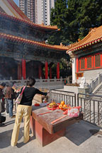 Woman placing incense. Wong Tai Sin Temple, Hong Kong, China. - Photo #15701