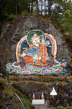 Large painting of Guru Rinpoche on a rock face. Road from Thimphu to Punakha, Bhutan. - Photo #23112