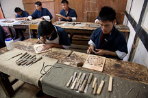 Young male students in the wood carving classroom. National Institute for Zorig Chusum, Thimphu, Bhutan. - Photo #22912