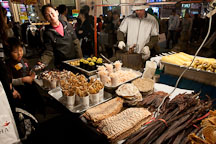Street vendor with many different kinds of food, including sweet corn and toasted seafood. Myeongdong, Seoul, South Korea. - Photo #20713