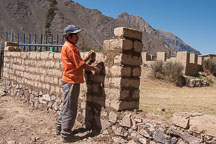Laborer building a brick wall. Sacred Valley, Peru. - Photo #9202