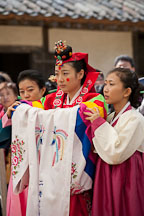 Traditional Korean wedding dresses are elaborate and brightly colored. The bride also wears a ceremonial headdress. - Photo #20522
