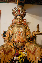North deva-king holding a pagoda in his right hand. Welto Temple, Po Lin Monastery. - Photo #16125