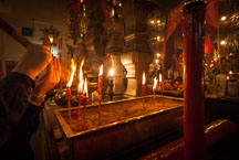 Lighting incense with candles. Man Mo Temple, Hong Kong, China. - Photo #15126