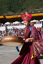 Monk beating drum in morning procession. Thimphu tsechu, Bhutan. - Photo #22427