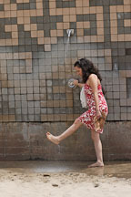 Young woman washing her feet. Manhattan Beach, Los Angeles, California, USA. - Photo #7328
