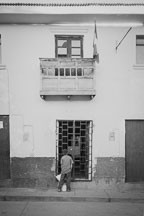 Boy in front of locked door. Cusco, Peru. - Photo #10235