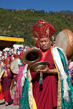 Monk using cymbals in the morning procession at Thimphu tsechu, Bhutan. - Photo #22438