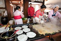 Women cooking Korean pancakes (pajeon) for visitors at the Korean Folk Village. - Photo #20539