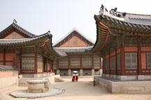 Women wearing traditional Korean hanboks stroll through the grounds of Gyeongbok Palace in Seoul, South Korea. - Photo #21004