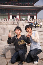 Korean schoolchildren stop to pose for a picture in front of Geunjeongjeon during a tour of Gyeongbok Palace in Seoul, South Korea. - Photo #20946