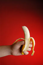 Banana in hand with red background - Photo #13853