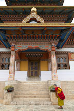 Old woman walks clockwise around the Khamsum Yuelley Namgyal Chorten. Punakha valley, Bhutan. - Photo #23354