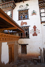 Paintings on the side of a house including a penis, deer,  garuda, and snow lion. Sopsokha, Bhutan. - Photo #23555