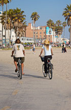 Couple bicyling on the Venice beach boardwalk. Venice, California, USA. - Photo #7466