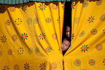 Young boys peeking out of the curtains. Thimphu tsechu, Bhutan. - Photo #22467