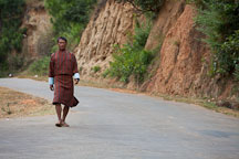 Man walking to town along the road. Punakha, Bhutan. - Photo #23269