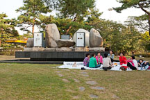 Women enjoy a picnic in front of artist Erik Dietman's sculpture, Yesterday and the Day Before Today and Tomorrow, at Olympic Park in Seoul, South Korea. - Photo #21678