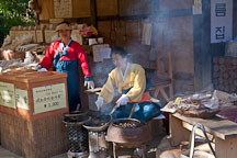 These women are making gun bam, or roast chestnuts at the Korean Folk Village. - Photo #20582